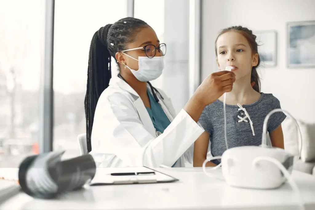 Doctor examining young girl in a clinical setting.