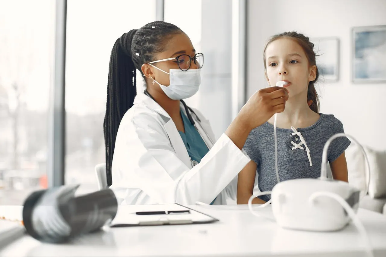Doctor examining young girl in a clinical setting.